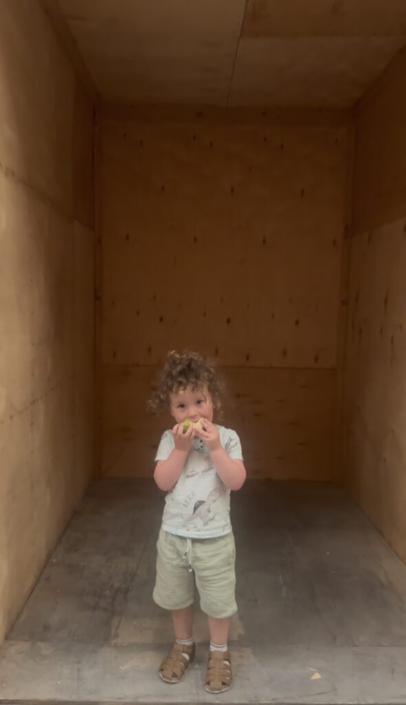 Wooden Storage Unit with two year old to compare size